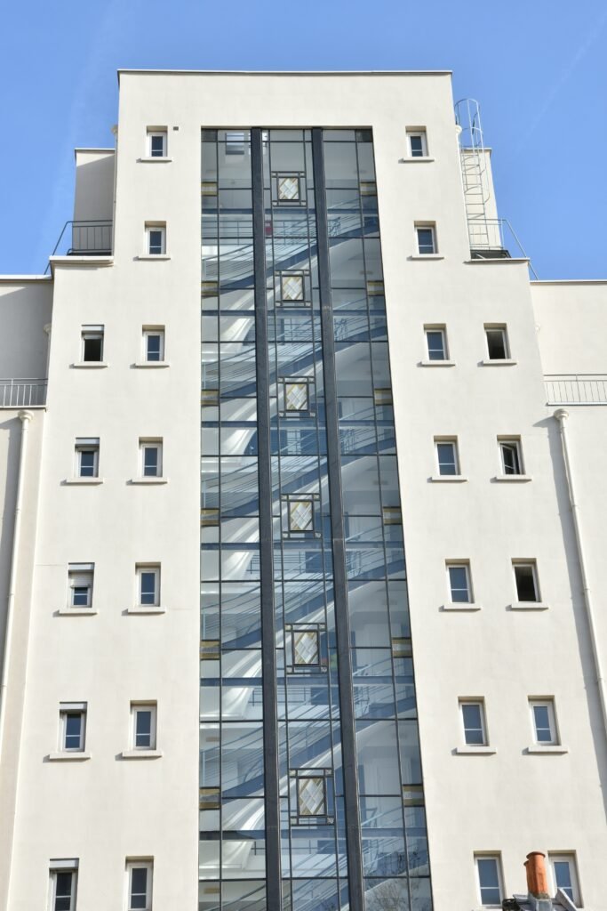 Modern residential building with glass elevator shaft and windows