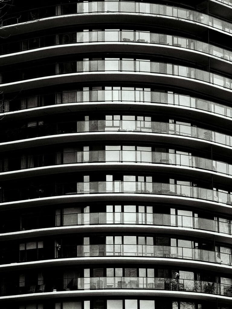 Modern apartment building with curved balconies and glass windows